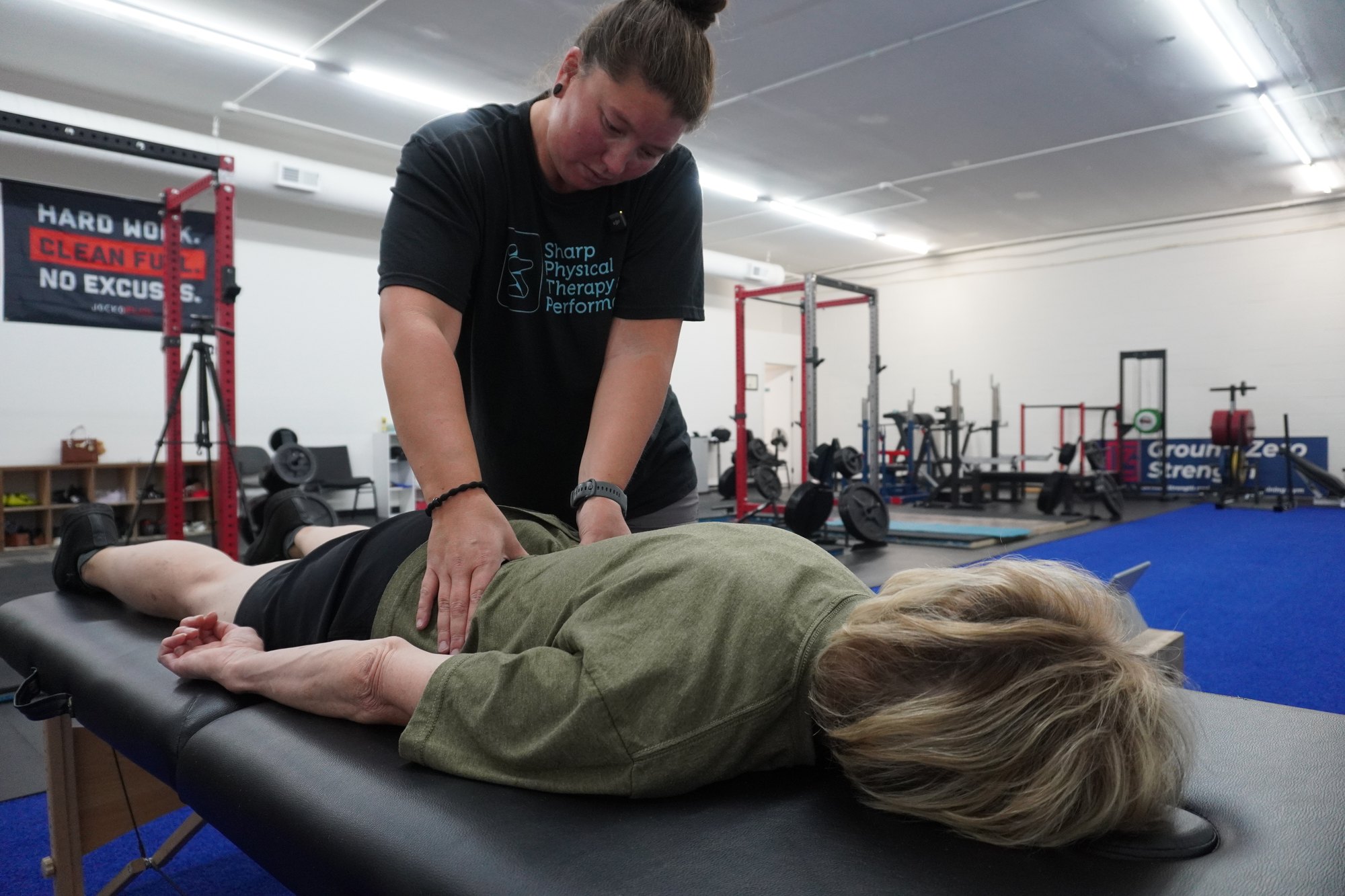 Dr. Nicole Sharp performing hands-on physical therapy with a client