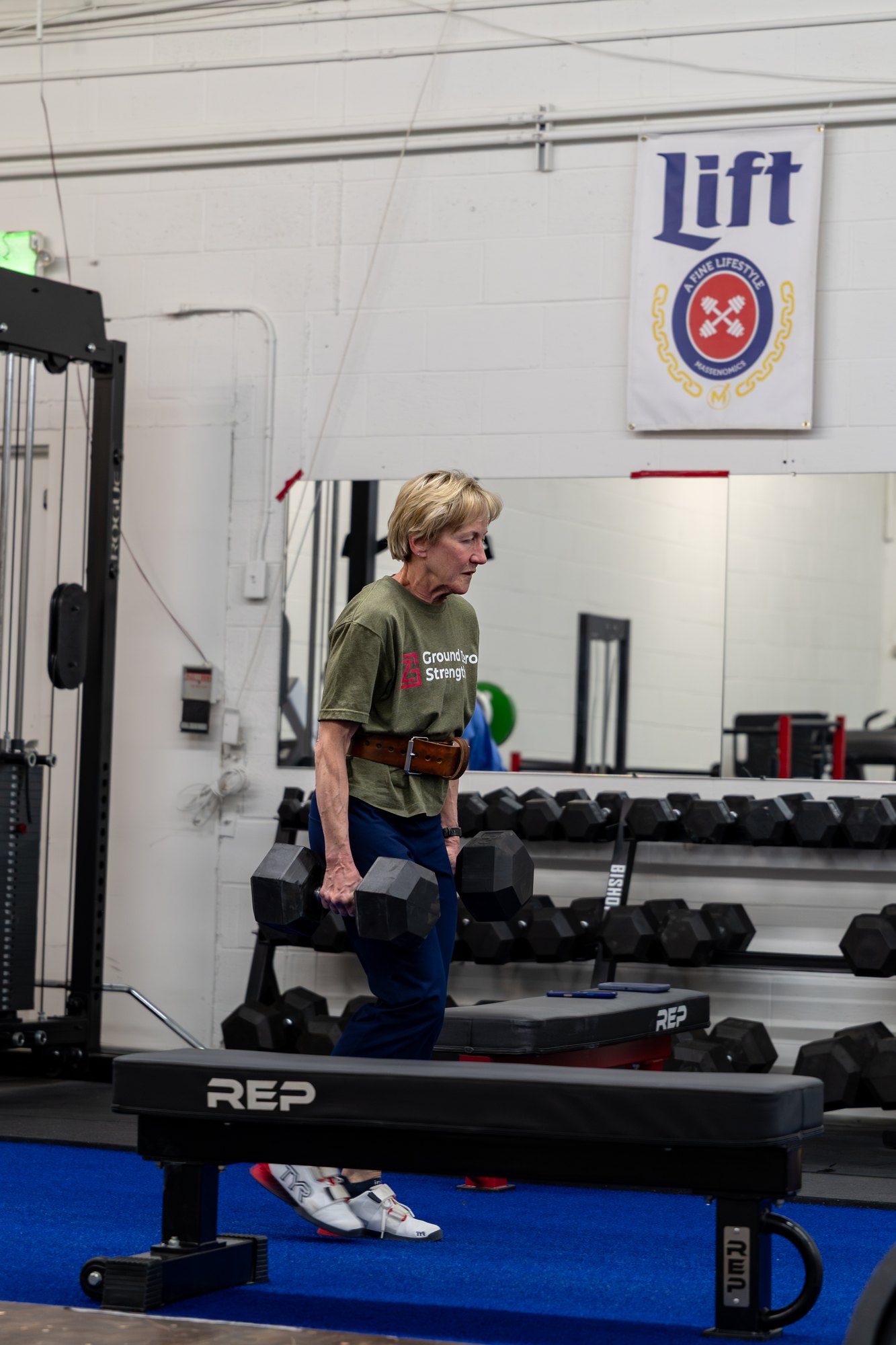 A woman training with dumbbells at Ground Zero Strength